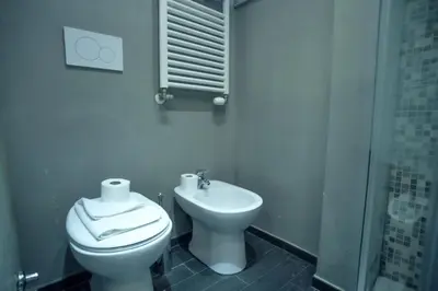 a bathroom with a toilet and a sink at Ponte Milvio Cozy 1BR Apartment in Rome