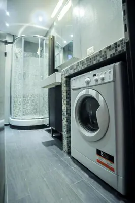 a washer and dryer in a bathroom next to a window at Ponte Milvio Cozy 1BR Apartment in Rome