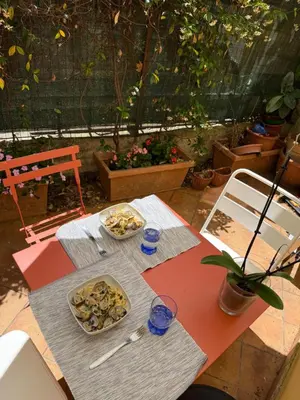 a table with two plates of food on it at Porta Metronia Suite in Rome