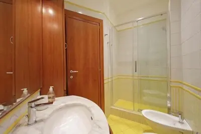 a bathroom with a sink and a shower at Porta Metronia Suite in Rome