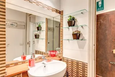 a bathroom with a sink and a mirror at NEW Navona Bright Apartment in Rome
