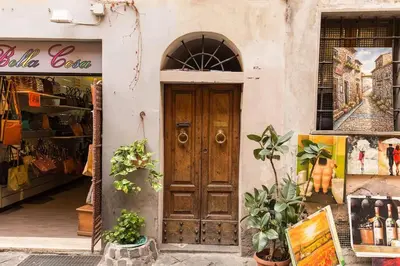 a store with a wooden door in a building at NEW Navona Bright Apartment in Rome