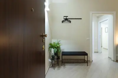 a hallway with a table and a bench in a room at Anastasia Comfort at the Vatican with Balcony in Rome