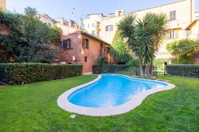a bedroom with a large white bed and a desk at Eos Retreat in Trastevere with pool in Rome