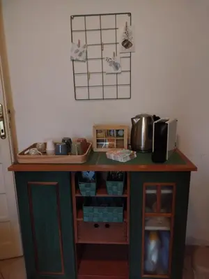 a kitchen with a table with a microwave at Camilla's House in Rome
