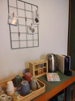 a kitchen counter with cups and a microwave at Camilla's House in Rome