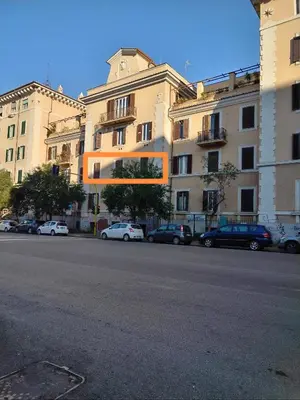 a building with cars parked on the side of a street at Camilla's House in Rome