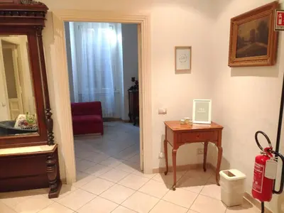 a living room with a red couch and a table at Camilla's House in Rome