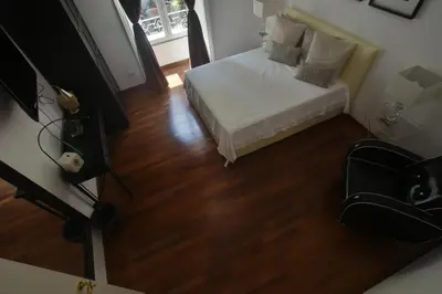 a small bedroom with a bed and a wooden floor at Piano Suite in Vatican in Rome