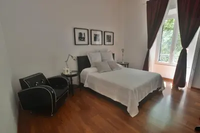 a bedroom with a bed and a chair at Piano Suite in Vatican in Rome