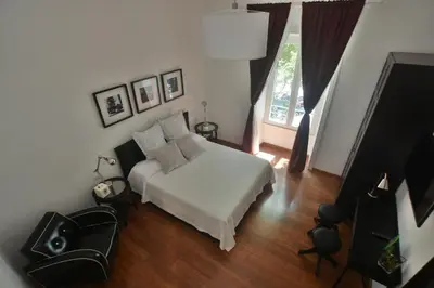 a bedroom with a white bed and a window at Piano Suite in Vatican in Rome