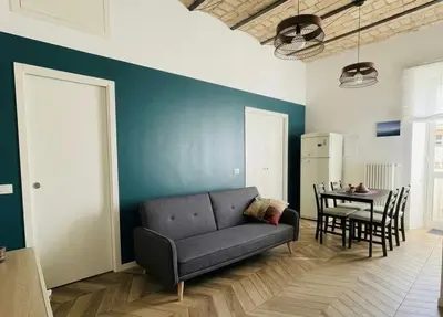 a living room with a couch and a table at Casa Mari - Cozy Apartment San Paolo Rome in Rome