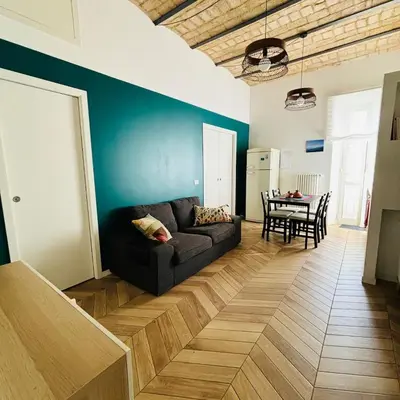 a living room with a couch and a table at Casa Mari - Cozy Apartment San Paolo Rome in Rome