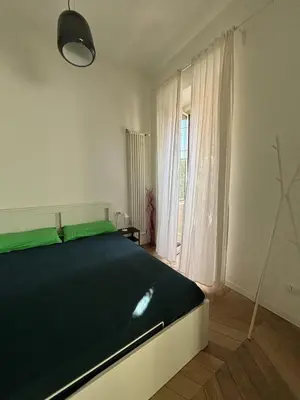 a bedroom with a large bed and a window at Casa Mari - Cozy Apartment San Paolo Rome in Rome