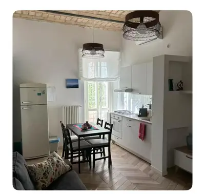 a kitchen with a table and chairs in a room at Casa Mari - Cozy Apartment San Paolo Rome in Rome