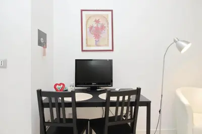 a desk with a computer and two chairs at CasAchille Mini Studio in Rome