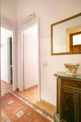 a room with a mirror on the wall and a table at Scipioni Suites in Rome