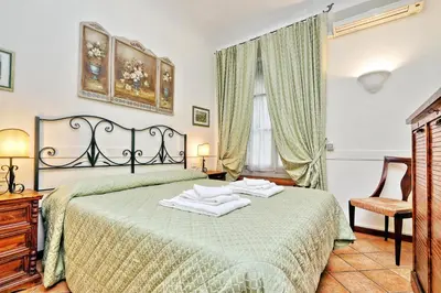 a bedroom with a bed with two towels on it at Scipioni Suites in Rome
