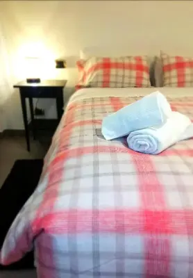 a bed with two towels sitting on top of it at Gianicolense Holiday Suite-Apartment in Rome