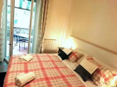 a bedroom with a bed with towels on it at Gianicolense Holiday Suite-Apartment in Rome