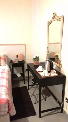 a room with a table with a mirror and a sink at Gianicolense Holiday Suite-Apartment in Rome