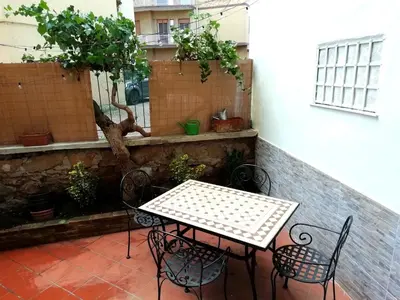 a patio with a table and chairs on a balcony at Gianicolense Holiday Suite-Apartment in Rome