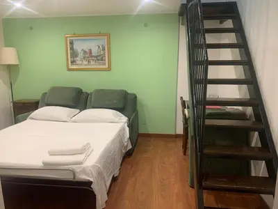 a bedroom with a bed and a spiral staircase at Apartment in historic palace in Rome