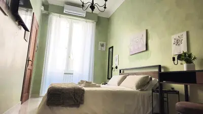 a bedroom with a bed with a teddy bear on it at Rome Boulevard Suite in Rome