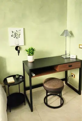 a desk in a room with a chair and a lamp at Rome Boulevard Suite in Rome