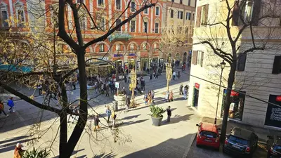 a group of people walking on a city street at Rome Boulevard Suite in Rome