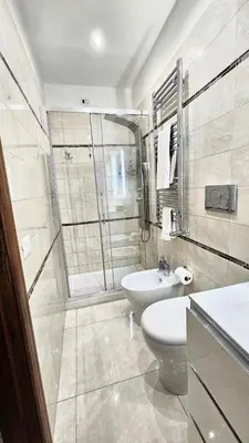 a bathroom with a toilet and a sink and a shower at Rome Boulevard Suite in Rome