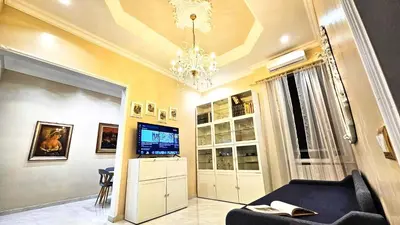 a living room with a black couch and a chandelier at Rome Boulevard Suite in Rome
