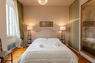 a bedroom with a large white bed with towels on it at Vatican Penthouse - Terrace with view in Rome