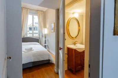 a bedroom with a bed and a sink and a mirror at Vatican Penthouse - Terrace with view in Rome