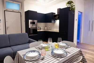 a dining table with plates and dishes on it in a kitchen at Testaccio Dream House in Rome