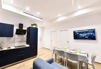 a kitchen and living room with a table and chairs at Testaccio Dream House in Rome