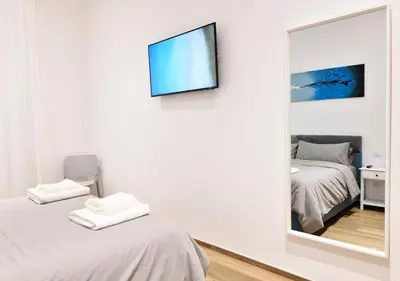 a bedroom with a mirror and a tv on the wall at Testaccio Dream House in Rome