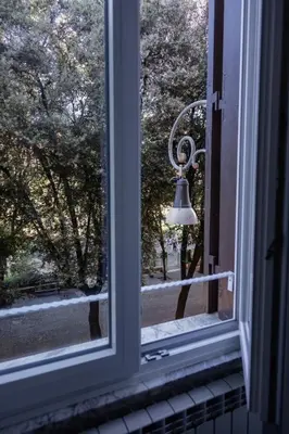 a window with a bell looking out of it at Testaccio Dream House in Rome
