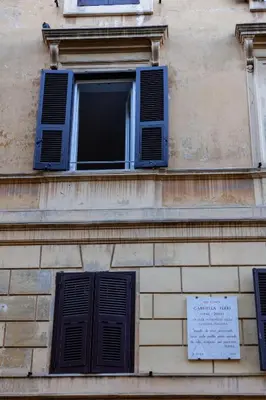 a window on a building with a sign on it at Testaccio Dream House in Rome