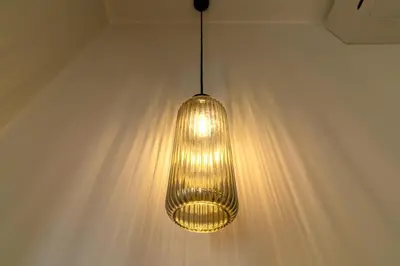 a light hanging from a ceiling in a room at Casa Barbieri boutique apartment Borgo Pio in Rome