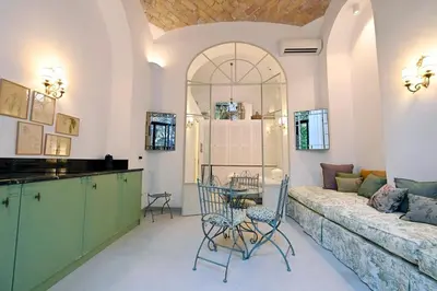 a living room with a couch and a table and chairs at Romantic Silent Garden in Rome