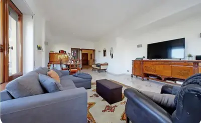 a living room with couches and a flat screen tv at Anastasio Spacious Apartment in Rome