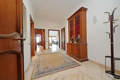 a hallway of a home with a door and a rug at Anastasio Spacious Apartment in Rome