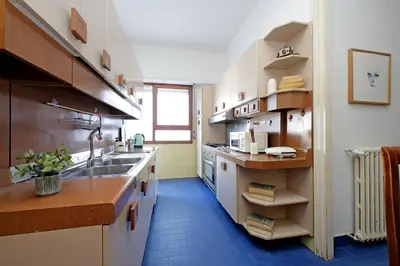 a large kitchen with a sink and a counter at Anastasio Spacious Apartment in Rome