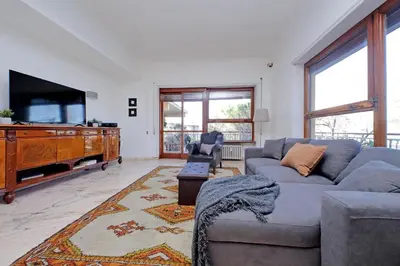 a living room with a couch and a flat screen tv at Anastasio Spacious Apartment in Rome