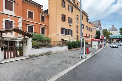 an empty city street with buildings and a car on the road at Vaticano San Pietro - Marisa Home - Check-in h24 in Rome