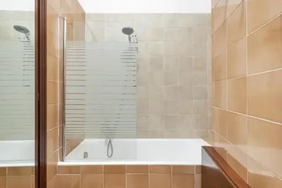 a bathroom with a bath tub with a shower at Vaticano San Pietro - Marisa Home - Check-in h24 in Rome