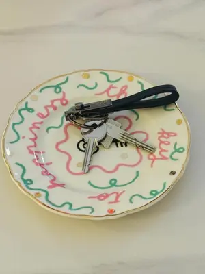a toy gun sitting on top of a plate with a happy birthday sign at Paolina Place in Rome