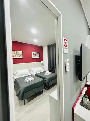 a room with two beds and a mirror at Cappadocia Rooms in Rome