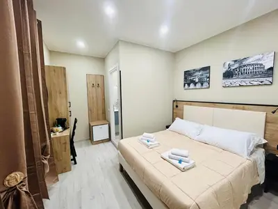 a bedroom with a bed with two towels on it at Cappadocia Rooms in Rome